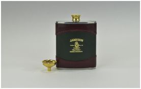 Jameson Irish Whiskey Hip Flask, bound in dark green and burgundy leather with gilt stopper and