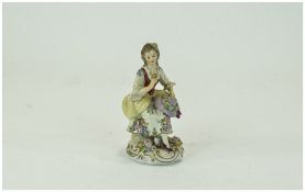 Sitzendorf Figure of a Young Woman, seated, in 18thC bucolic dress and with a floral theme,