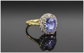 18 Carat Gold Set Diamond Dress Ring. The central Blue Gemstone surrounded by 20.5mm diamonds.