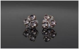 Rose Quartz Trefoil Stud Earrings, each earring having three round cut, faceted rose quartz set in