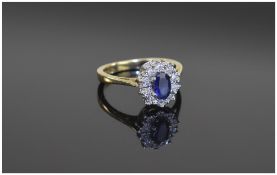 9 Carat Gold Diamond Cluster Ring central sapphire surrounded by round cut diamonds.