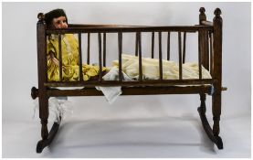 Early 20thC Doll jointed body and head, looks to be German. Together with a wooden spindled cot.