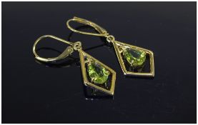 Pair of Peridot Drop Earrings, each earring comprising a 1ct pear cut peridot suspended within a