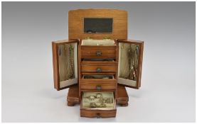 A Wooden Jewellery Box In The Form of a Chest of Drawers with Lift up Top - Containing a Gold