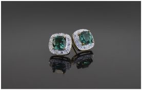 9 Carat Gold Diamond Set Stud Earrings central green stone and diamond chips.