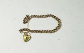 A 9ct Gold Curb Bracelet with Padlock and Safety Chain. Fully Hallmarked for 9ct Gold.