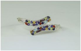 Multi Gemstone Crossover Bangle, set with fire opal, amethyst, sky blue topaz, peridot, rhodolite