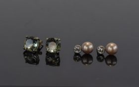 Two Pairs of Silver Earrings one set with topaz the other with cz and pearl.