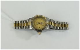 Ladies Designer Tag Heuer Wristwatch, gilt dial, baton numerals. bi metal bezel and bracelet strap.