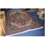 Large Woolen Room Size Rug predominately red ground with floral decoration.