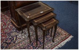 Nest Of Three Tables Mahogany Finish, Leather Tooled Tops With Glass Covers.