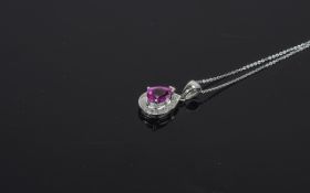 9 Carat White Gold Diamond Set Pendant central pear shaped pink sapphire surrounded by round cut