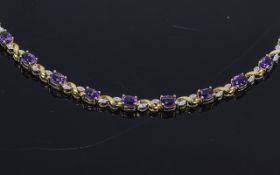 9 Carat Gold Tennis Gem Stone Bracelet set with Amethysts and round brilliant cut diamonds.