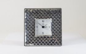 A Modern Silver Table Clock with Overlap