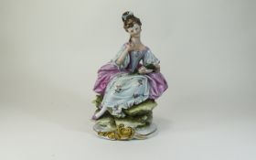 Capodimonte Figure of a Seated Girl, in 18th century costume, pink dress over a pale blue,