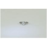18 Carat White Gold Single Stone Diamond Ring set with a round brilliant cut diamond between