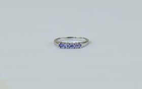 9ct White Gold Dress Ring set with a row of round cut tanzanites. Fully hallmarked.