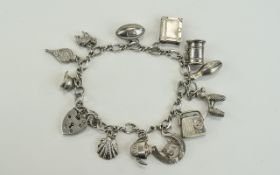 A Vintage Silver Bracelet Loaded with 13 Charms. All Charms Fully Marked for Silver. 30.
