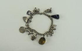 A Vintage Silver Bracelet Loaded with 11 Charms. All Charms Fully Marked Silver. 38.