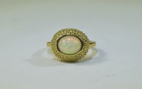 Natural Opal Solitaire Ring, an oval cut cabochon opal of 1.5cts, bezel set in a 14ct gold vermeil