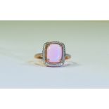 Pink Opal Solitaire Ring, an elongated cushion cut cabochon pink opal of 3cts, set in rose gold