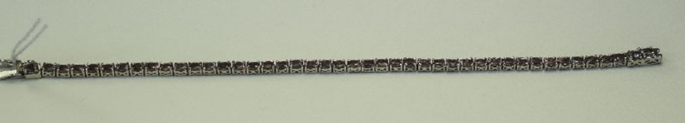 Malaya Garnet Tennis Bracelet, a row of oval cuts of the unusual malaya garnet,