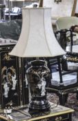 A Stylish and Impressive Black Lacquered Table Lamp with Applied Decoration of Ivory Style Figures.