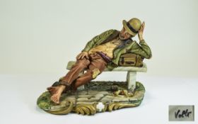 Capodimonte Volta Figure, showing a very tall tramp reclining on his suitcase on an uncomfortable