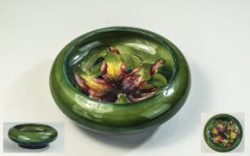 W. Moorcroft Inverted Footed Bowl ' Columbine ' Design on Green Ground. c.1950's. Diameter 5 Inches.