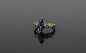 18 Carat Gold Sapphire and Diamond Ring central marquise cut sapphire between tapered baguette