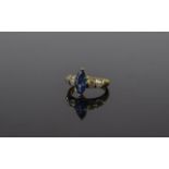 18 Carat Gold Sapphire and Diamond Ring central marquise cut sapphire between tapered baguette