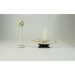 An Early 20th Century Small Carved Ivory Figural Stand with Puzzle Ball. 6.