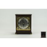 Elliot Mantel Clock with Silvered Chapter Ring, Ornate Fingers, Raised on Four Ball Feet. Height 6