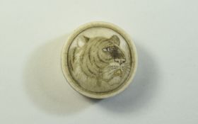 A Small Early 20th Century Ivory Circular Lidded Pill Box with Image of a Tigers Head to top of Lid.