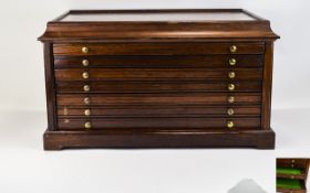 A Large Mahogany Coin Cabinet with Seven Pull Out Drawers and Twin Bases, Carrying Handles.