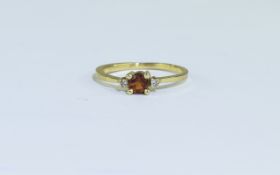 14ct Gold Dress Ring set with a central round fire opal between 2 round cut diamonds. Stamped 14K.