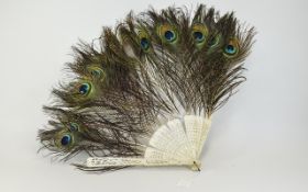 Early 20thC Bone Framed Hand Fan with peacock feathers. A/F condition.
