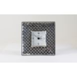 A Modern Silver Table Clock with Overlapping Shell Design to Front, Mahogany Back, Chrome Supports.