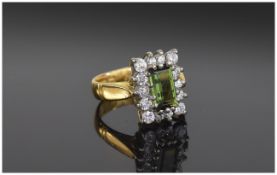 22 Carat Gold Set Dress Ring. The emerald cut sapphire surrounded by 14 small diamonds. Fully