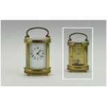 French 19th Century Quality and Shaped Brass Carriage Clock With Glass Panels. Visible Escapement
