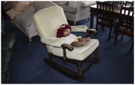 Rocking Chair Wooden Frame With Light Green Upholstery Together with a rag doll.