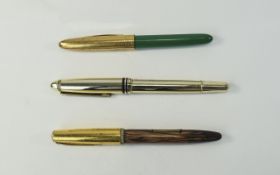 Three Fountain Pens two with gold nibs.