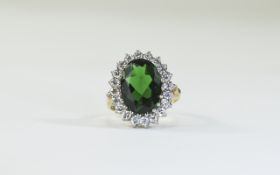 9 Carat Gold Dress Ring set with central green stone, surrounded by clear faceted. Fully hallmarked.