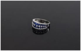 Sapphire and White Zircon Band Ring, two rows of graduated, round cut, blue sapphires, to either