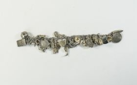 A Mid to Late 20th Century Silver Charm Bracelet, Loaded with 33 Silver Charms.