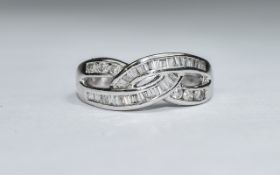 18ct White Gold Set Criss Cross Baguette and Brilliant Cut Diamond Ring. Marked 750.