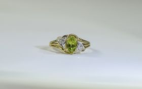 9 Carat Gold Dress Ring central peridot, set between diamond chips. Fully hallmarked.