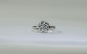 18 Carat Gold Diamond Cluster Ring set with 7 round brilliant cut diamonds. Est diamond weight .