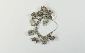 A Silver Charm Bracelet Loaded with 10 Silver Charms, All Fully Hallmarked for Silver.