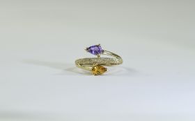 9 Carat Gold Dress Ring set with 2 round pear shaped gemstones and textured gold design.